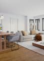 wooden dining table, gray chairs, wooden sofa, beige rug, modern interior, open plan