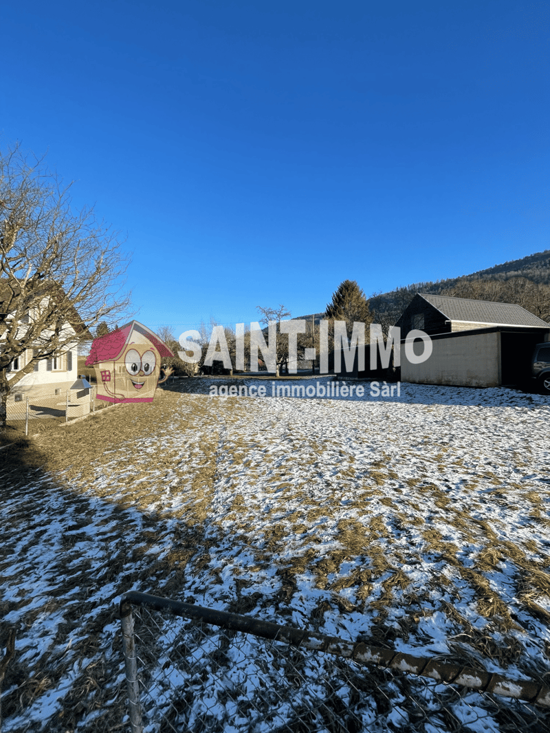 Outdoor lot for building, snowy, with house on left and building on right