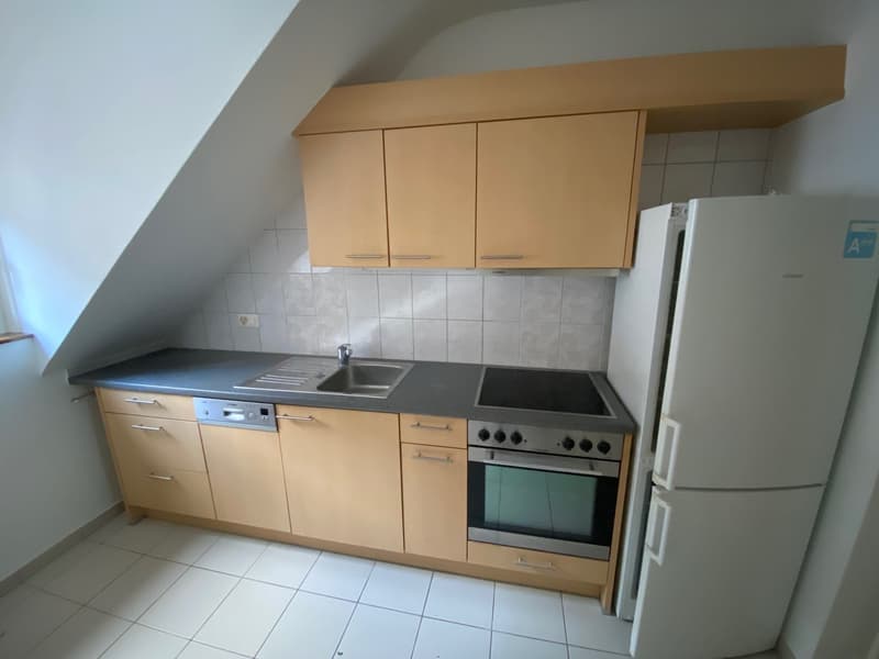 kitchen with wooden cabinets, tiled flooring, built-in appliances