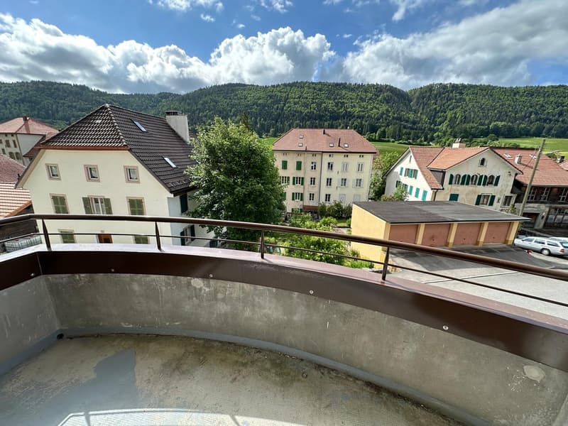 Building with multiple houses, balcony, mountain view