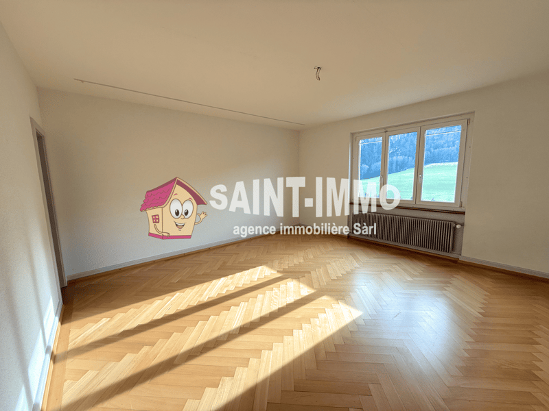 empty room, wooden parquet floor, large window, wall with a radiator, light from the window