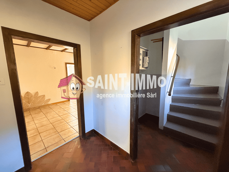 tiles floor, wooden ceiling, tile and parquet floor, two doors and stairs leading to the upper floor