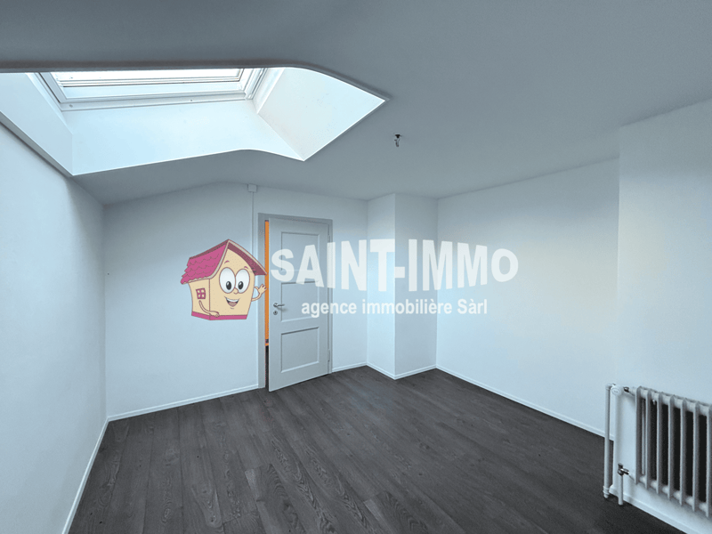 empty room, skylight, wooden floor, white walls, radiator