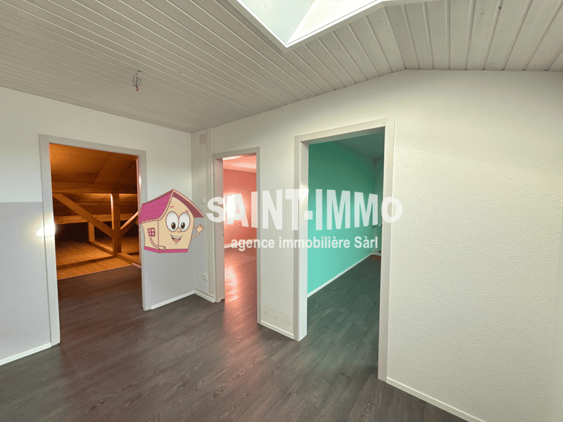 empty room, wooden floors, white walls, skylight, three doors leading to other rooms