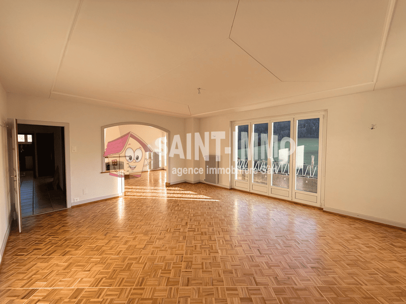 Open floor plan, wooden parquet floor, double doors, arched entryway, sliding glass doors, large windows