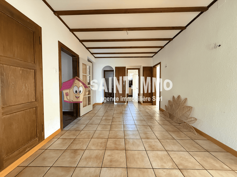 empty hallway, brown wooden doors, tiled floor, wooden beamed ceiling