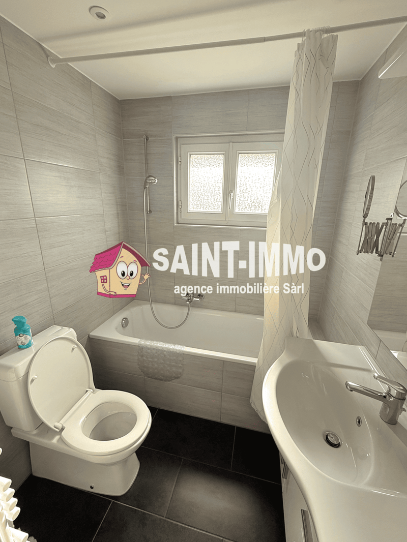 Bathroom with bathtub, toilet, sink, and shower curtain