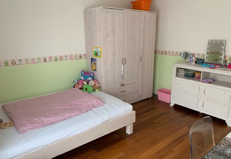White bed, wooden floor, green wall, white wardrobe, white desk, mirror