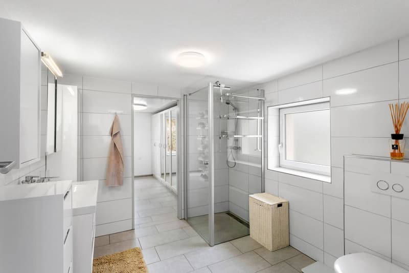 white tiles, glass shower, white cabinet, sink, radiator
