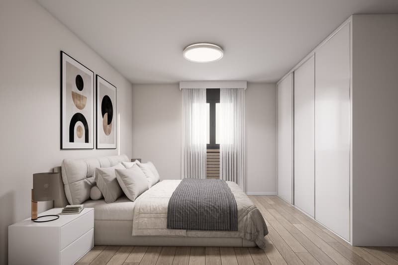 modern bedroom with bed, nightstand, lamp, artwork, sliding doors, wardrobes, ceiling light