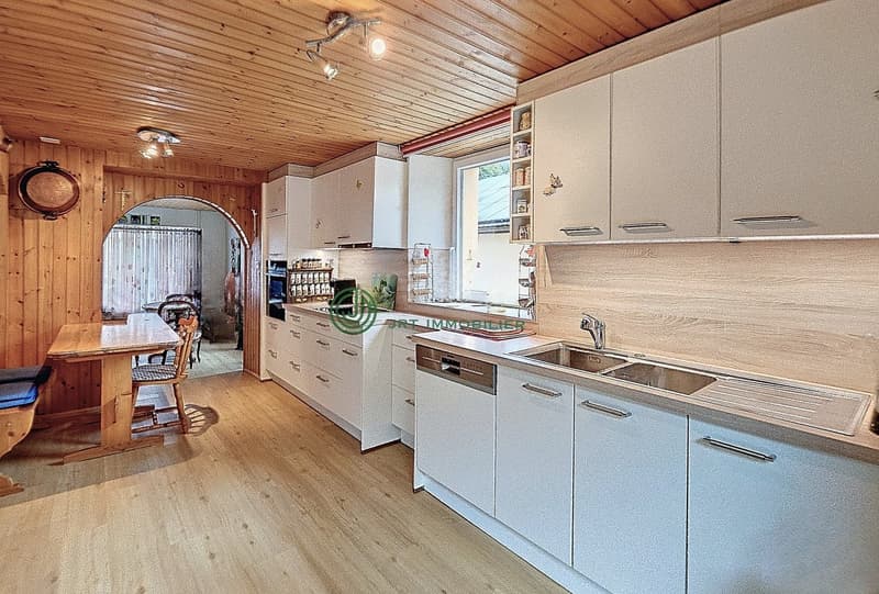 modern kitchen, wooden floor, white cabinets, wooden table, dishwasher, sink, wooden ceiling