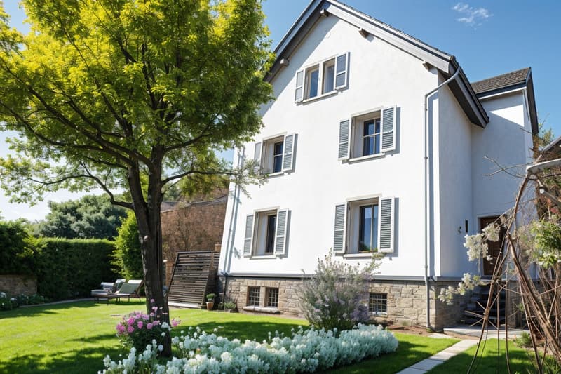 2 story house, white exterior, gray roof, large windows, garden, tree, flowers, lounge chairs