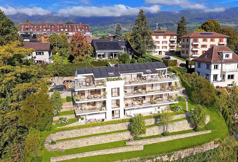 Modern multi-story house, solar panels on the roof, multiple balconies, landscaped garden, stone walls