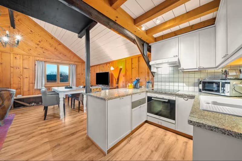 Open plan living space, dining area, fireplace, kitchen, desk, television, chairs, table, carpet, wood flooring