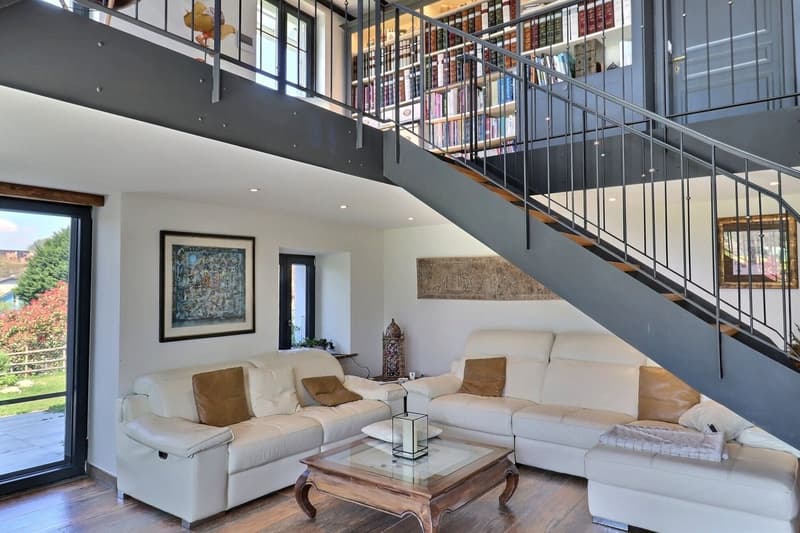 two sofas, large glass doors, modern design staircase, wood flooring, coffee table, view of the outside