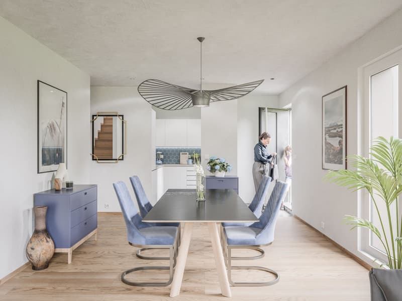 modern dining room, hardwood floor, dining table and chairs, pendant light, blue side table, artwork, staircase, windows, vase, plant