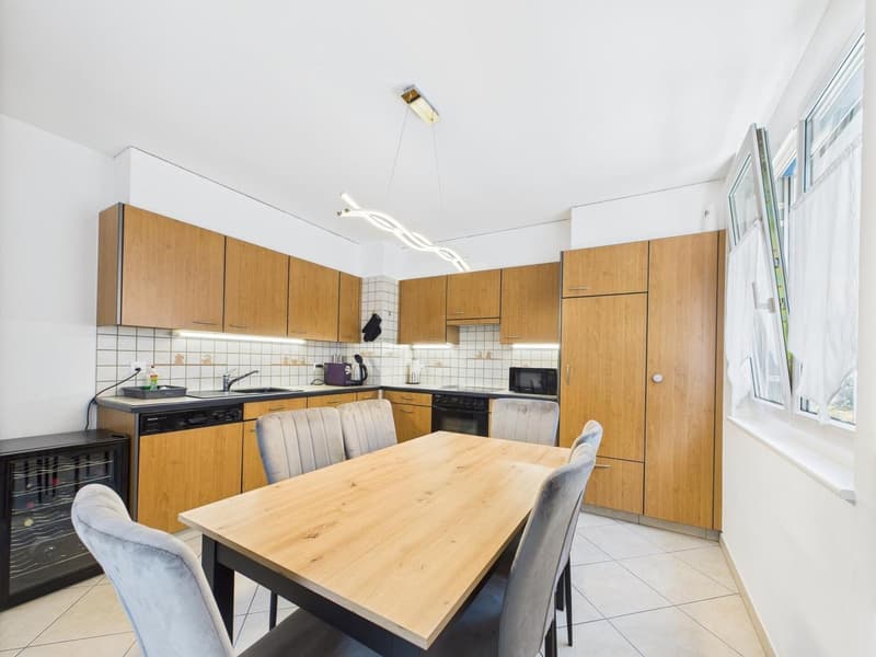 modern wooden cabinets, tiled backsplash, large dining table with 6 chairs, white ceiling, open shelving, under-cabinet lighting, wine cooler, dishwasher, white tile flooring