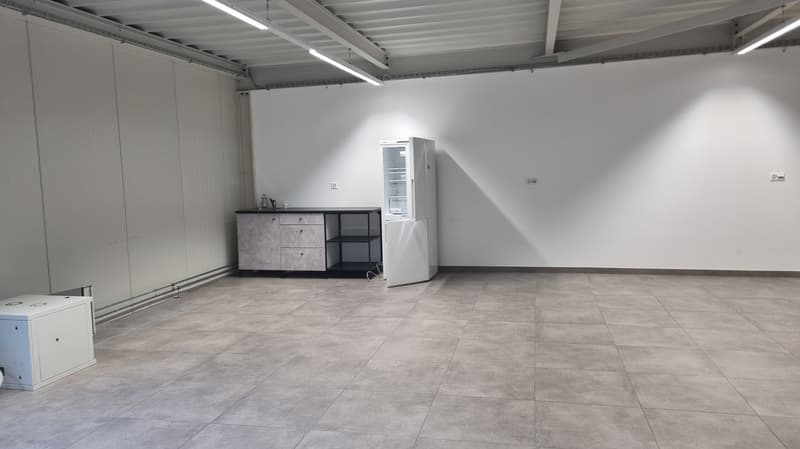 Empty room, tiled floor, white walls, open refrigerator, cabinets with drawers, shelves, power outlet.