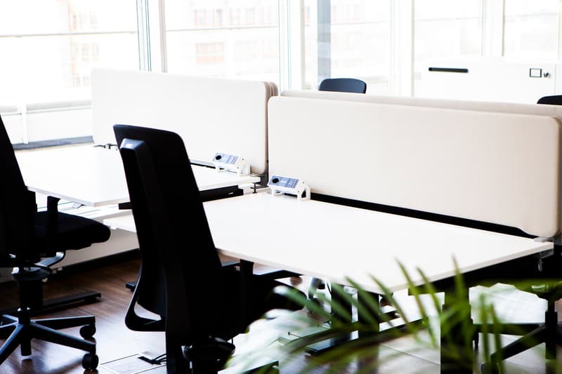 modern office setup with partitioned desks and black office chairs