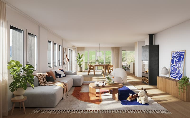Spacious open-plan living area with large windows, grey sectional sofa, wooden dining table, fireplace, and various decorative elements such as plants and artwork