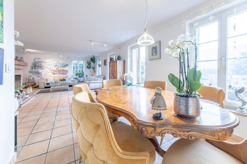 dining table, chairs, fireplace, large windows, painting on the wall, flower vase