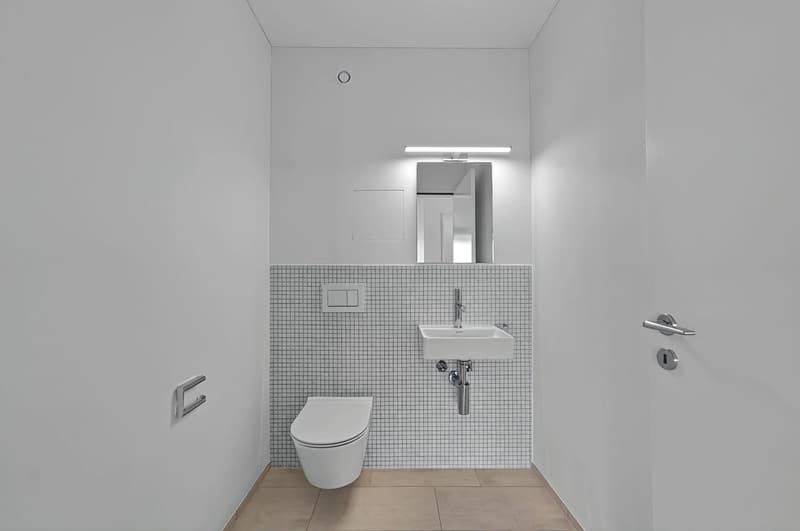 compact bathroom with white walls and flooring, modern design with minimalist white toilet and wall-mounted sink