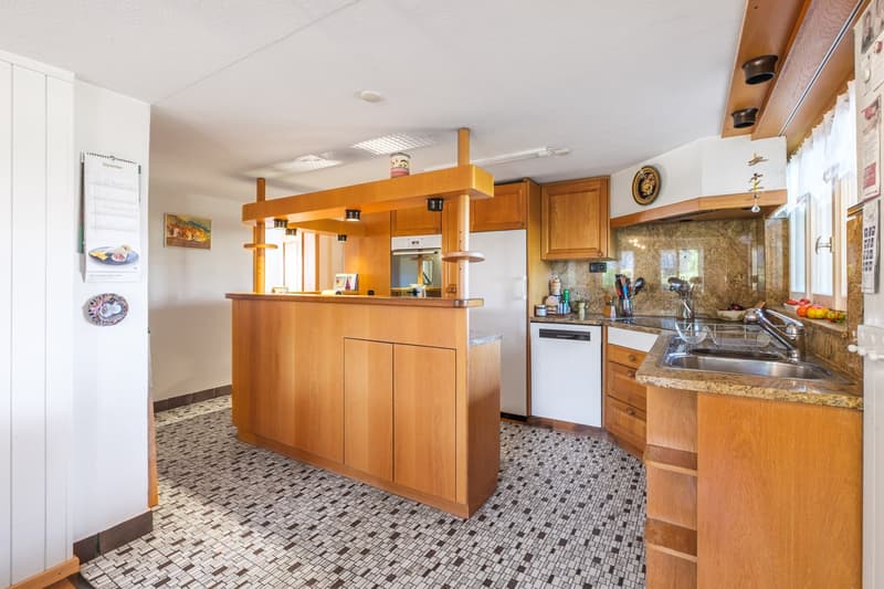 Open kitchen, modern design, black and white checkered tiles, wooden cabinets, center island, white appliances, granite countertops, stainless steel sink, faucet, and storage shelves