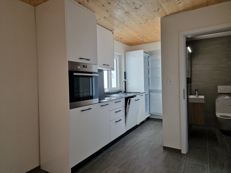 modern kitchen with white cabinets, stainless steel appliances, wooden ceiling, tiled floor, sink with faucet, dishwasher, washing machine