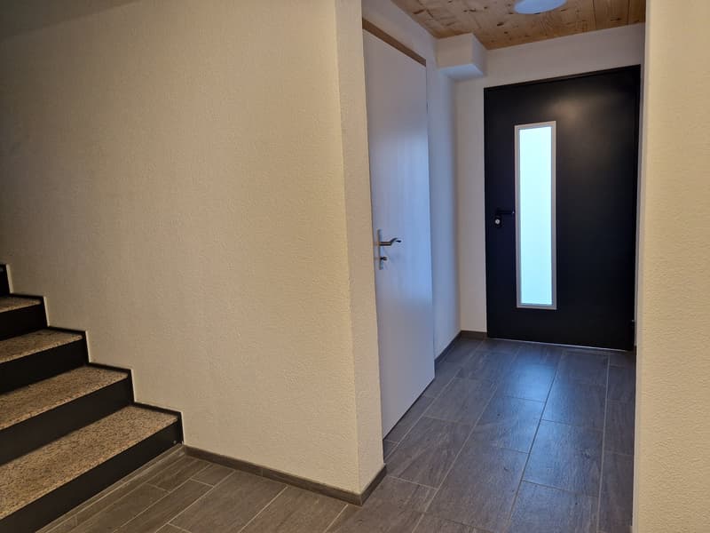tiled floor, white walls, black door, white door, stairs