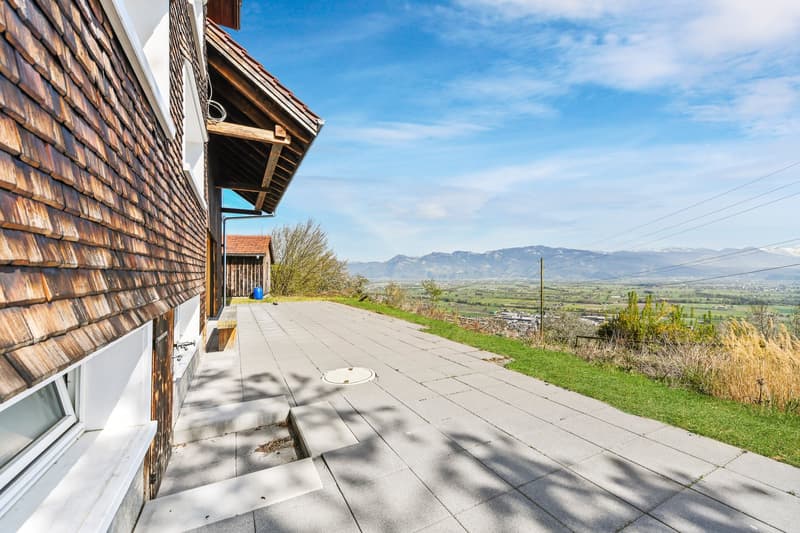 wooden exterior, raised ground floor, paved walkway, view of mountains