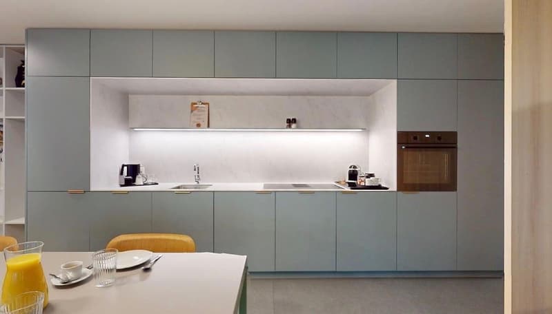 grey cabinets, silver countertops, stainless steel appliances, built-in oven and sink