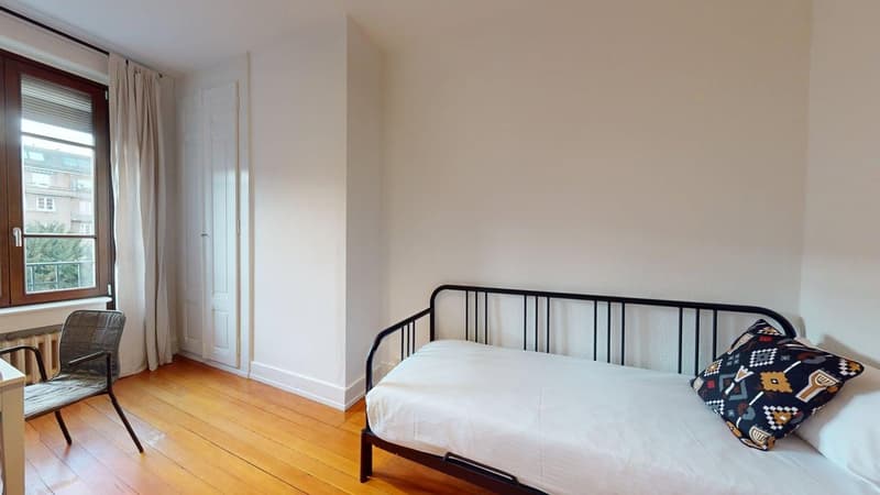 wooden floor, day bed, chair, window with curtains, door, radiator