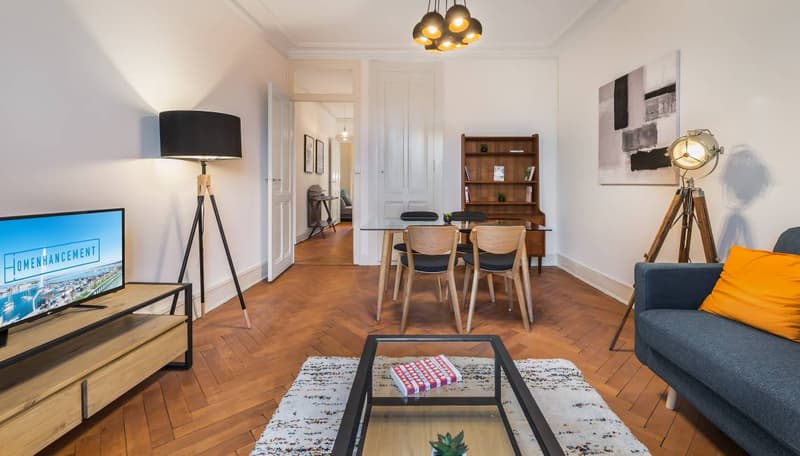 wooden floor, white walls, living room, wooden table, dining table, TV, lamp, couch, rug, wooden stand