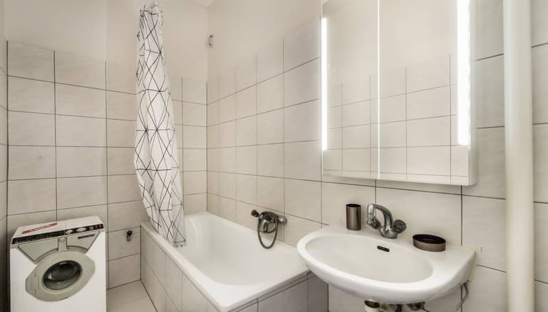 White tile, bathtub, shower curtain, white sink, white mirror, private washing machine