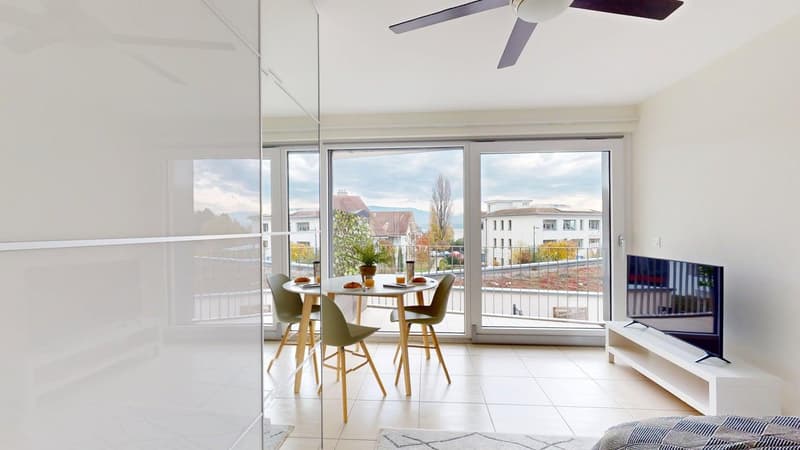 small dining area with table, chairs, sliding glass doors, balcony, television, white floor