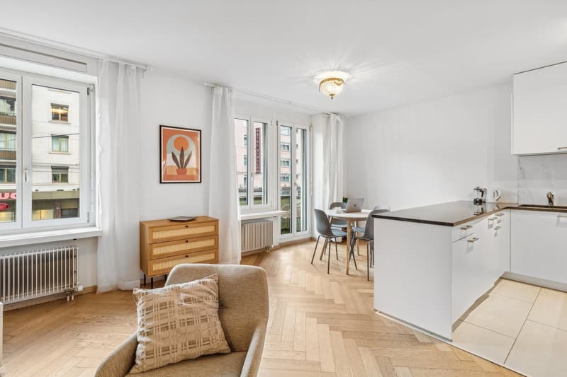 open living and dining room with kitchen, large windows, wooden floor, modern furnishings, table with chairs, radiators, a picture on the wall, couch with pillow