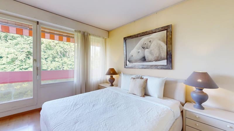 Queen-size bed, two nightstands with lamps, white wall, wooden floor, white nightstand, nightstand lamp, picture on the wall, sliding doors to balcony, curtains