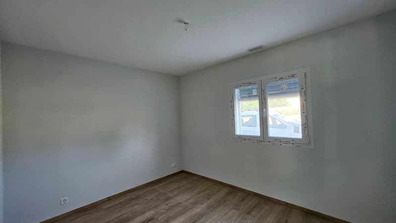 empty room, wooden floor, white walls, power outlet, window with white frame