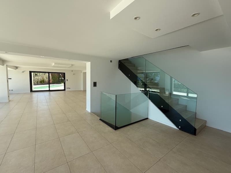 empty room, tiled floor, glass staircase, glass railing, white walls, large windows
