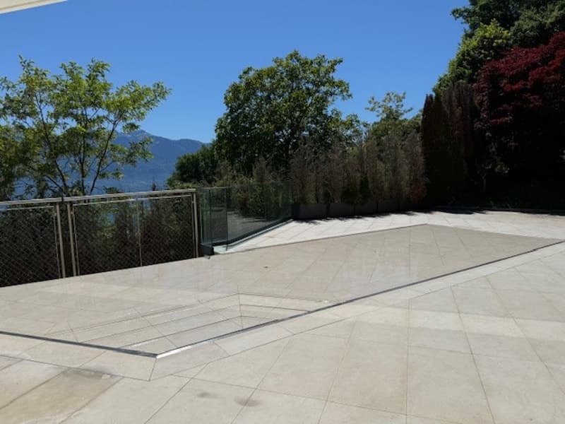 tiled floor, metal fence, glass fence, trees, mountains, view