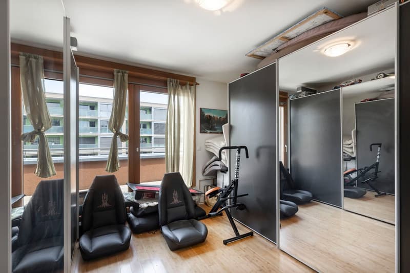 wood floor, windows with curtains, chairs, shelves, exercise equipment, mirror