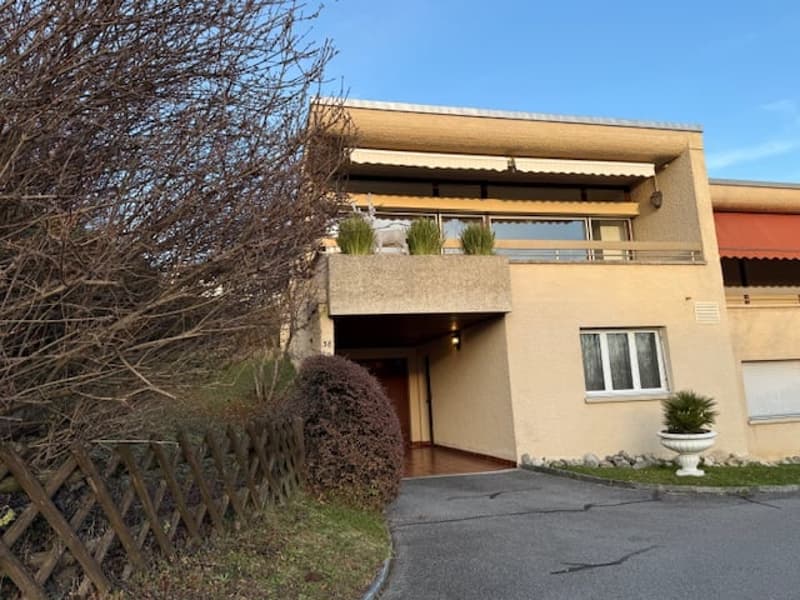 2 story house, beige color, glass windows, terrace, garage, driveway