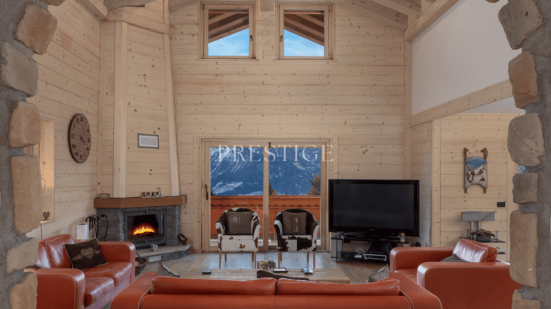 Fireplace, leather couches, flat screen tv, windows, large glass doors