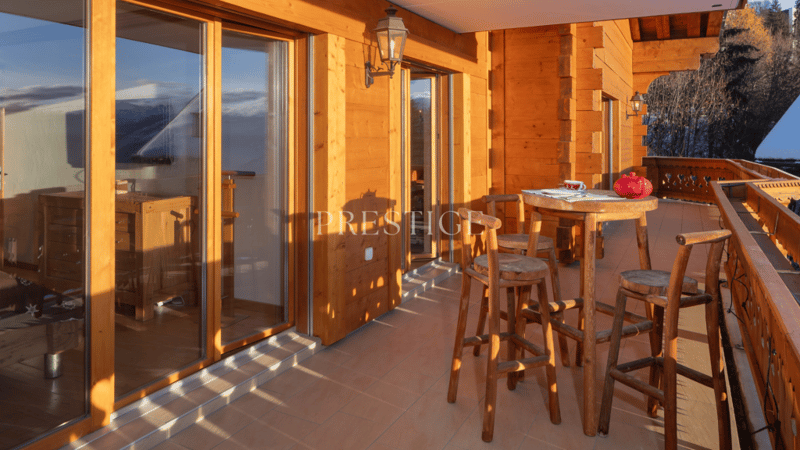 Wooden walls, sliding glass doors, wooden chairs, wooden table, lamps