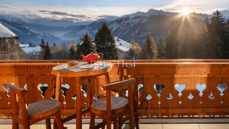 wooden table and chairs, teapot, cup, mountains in the background, sunny