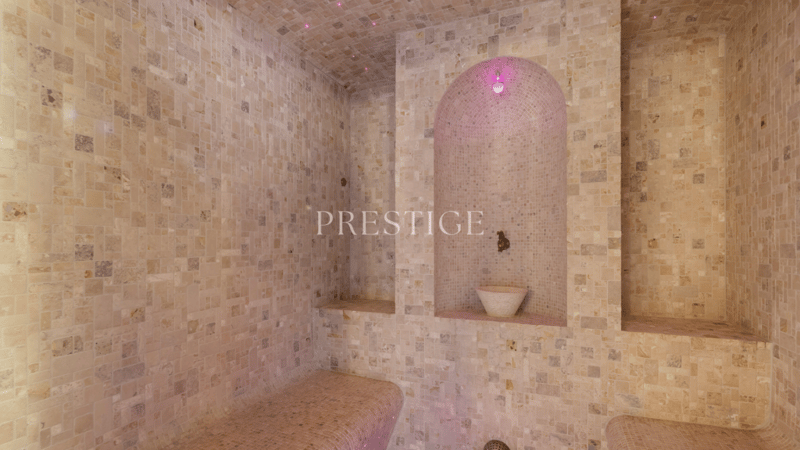 A room with stone tiles and benches, a small water bowl, and decorative lighting