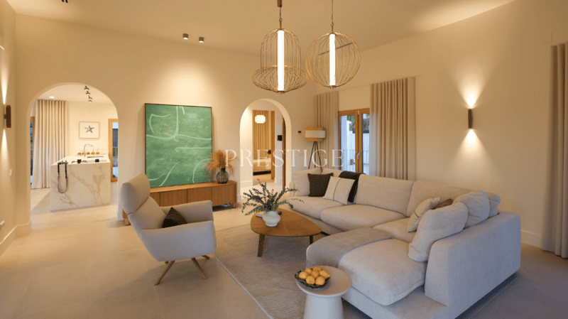 modern living room, large windows, white couch, wooden coffee table, white armchair, white rug, modern art painting, wooden cabinet, white marble countertop, sink, faucet