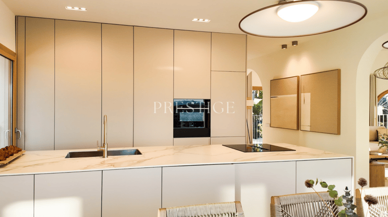 modern kitchen, marble countertop, stainless steel sink, built-in oven, dishwasher, white cabinets, wooden floor