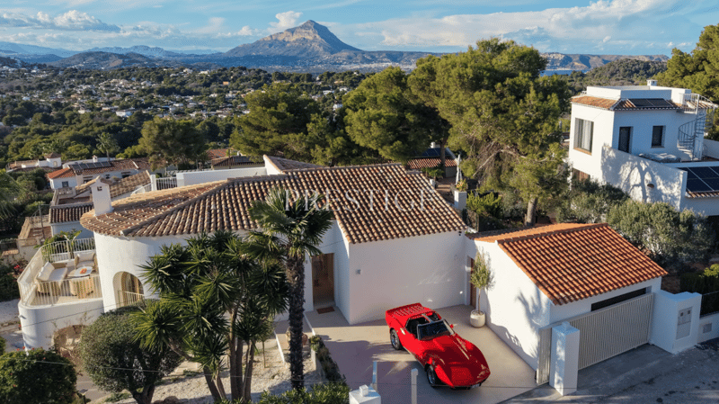 Modern house, white walls, red roof, garage, car parked, trees, mountain view