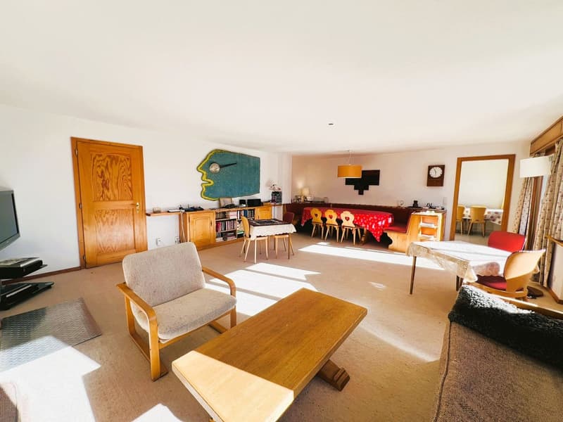 Wooden floor, modern and neutral tones, with multiple furniture pieces like couches, tables, chairs, and cabinet.
